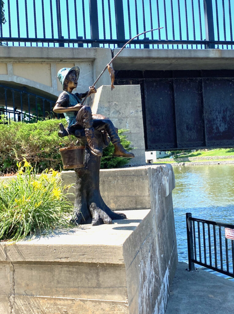 Memorial 'fishing boy' statue finds home along Riverwalk